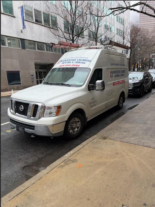 White service van of Maintenance Unlimited Heating & Cooling parked on a city street in Atlanta, GA.
