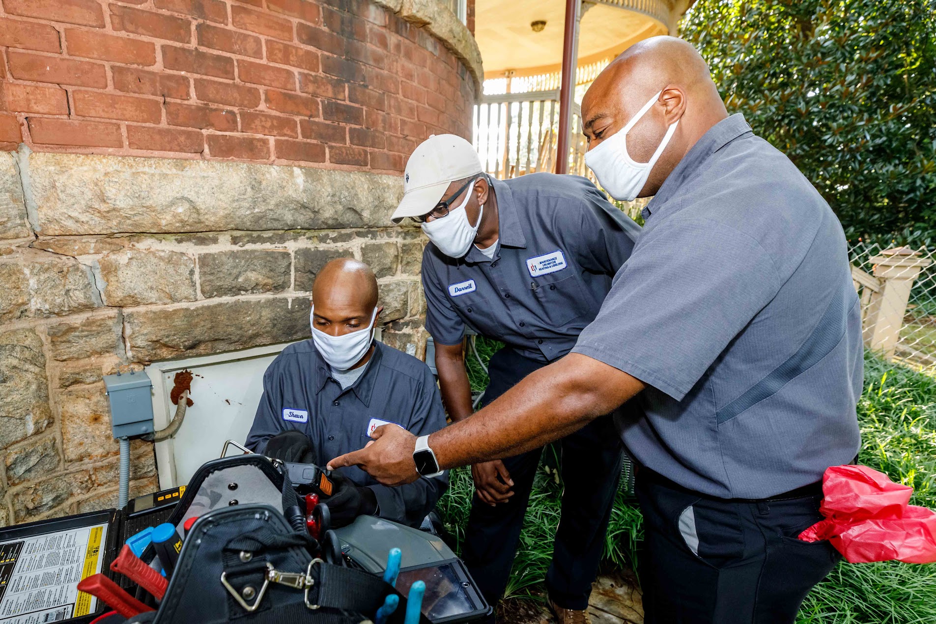 HVAC technician installs a new air conditioning unit outside a home in Atlanta, GA.