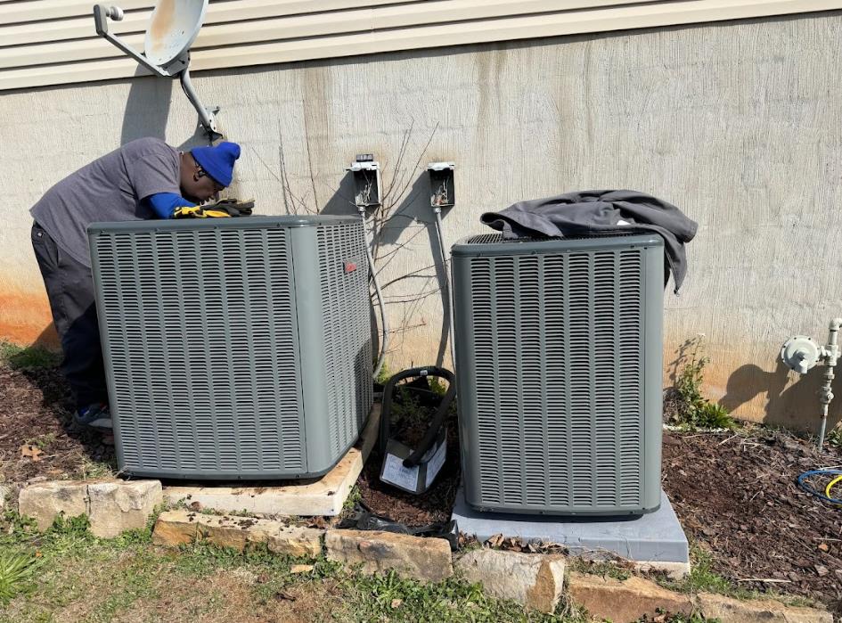 Technician repairs an outdoor air conditioning unit in Atlanta, GA.
